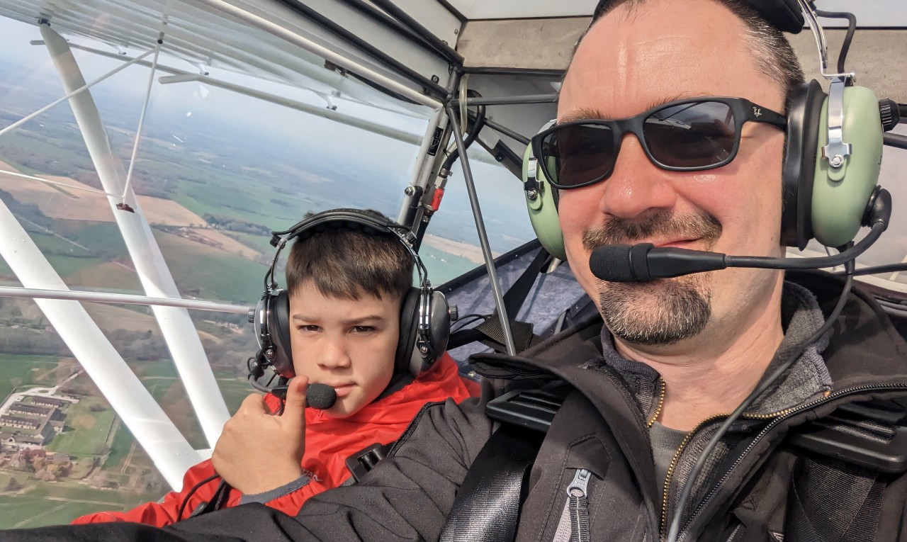 Father and son in the cockpit of a microlight